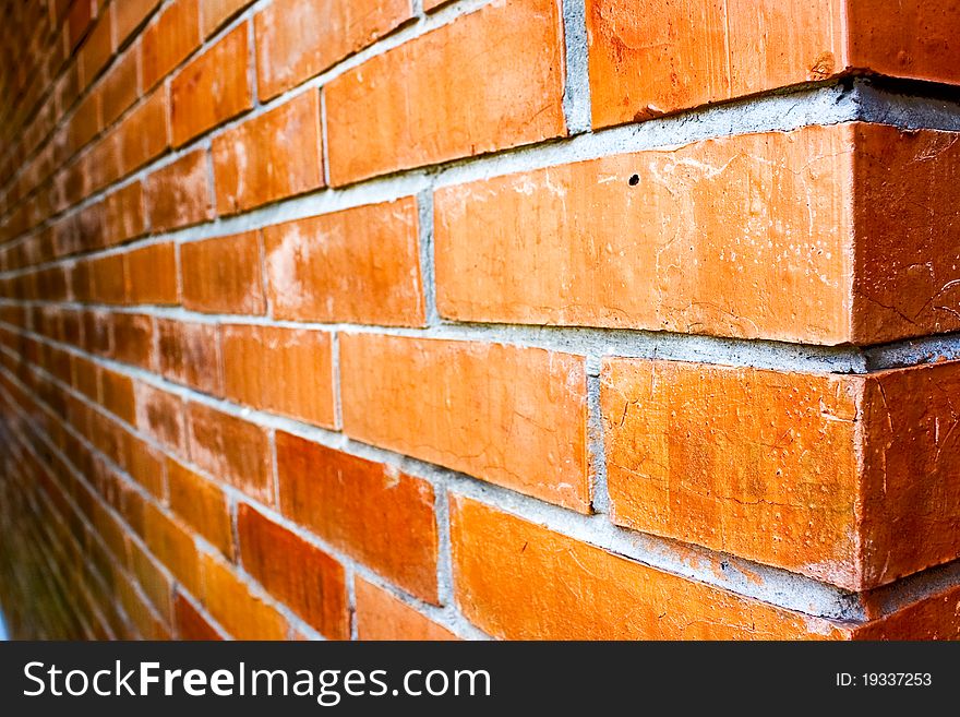 Close-up of a orange-brown brick wall.