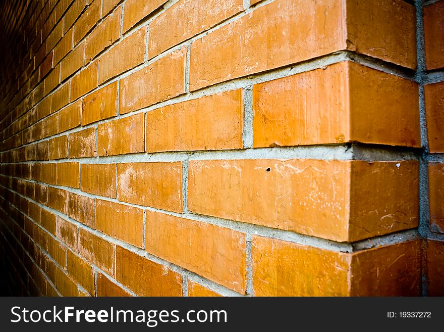 Close-up details of an orange-brown brick wall.