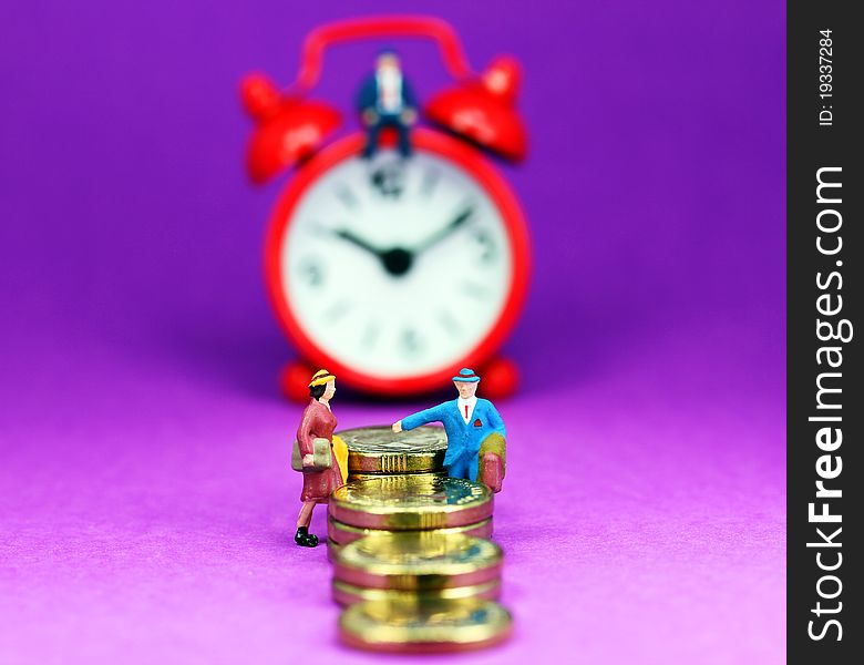 A couple on a gold coin stairway with a red alarm clock in the background with the bank manager sat on top of the clock and with a pastel purple background, asking the question how long before you will be free of the bank and its loan. A couple on a gold coin stairway with a red alarm clock in the background with the bank manager sat on top of the clock and with a pastel purple background, asking the question how long before you will be free of the bank and its loan