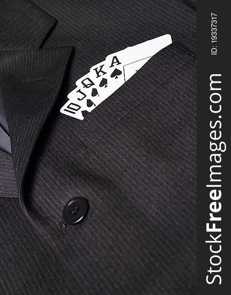 Royal straight flush with playing cards in gray suit pocket. Royal straight flush with playing cards in gray suit pocket