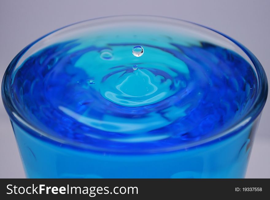 Water drop in a cup
