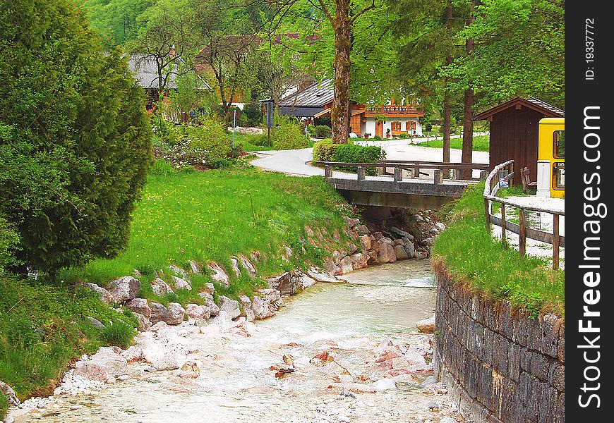 Stream in the Alpine village. Austrian Alps. Spring