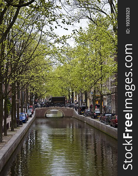 Canal in Amsterdam. Spring cityscape. Bicycles are on the waterfront.