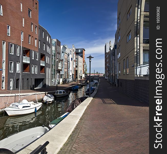 Modern residential houses on the canal in Amsterdam. Spring cityscape.