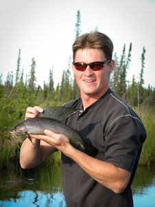 Free Man With Arctic Grayling Fish Royalty Free Stock Photo - 19345635