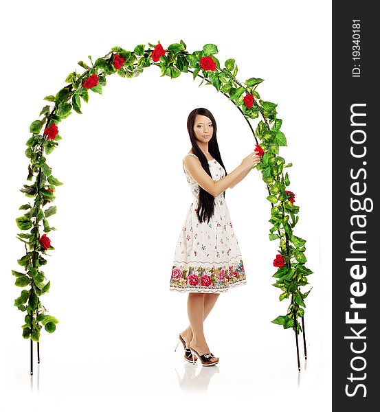 Picture of cute girl on the background of the arch entwined by roses. Picture of cute girl on the background of the arch entwined by roses