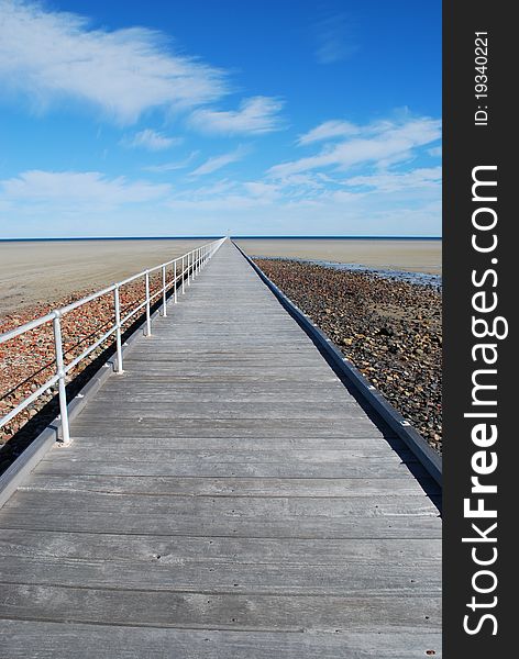 Endless wooden jetty at low tide
Blue horizon. Endless wooden jetty at low tide
Blue horizon