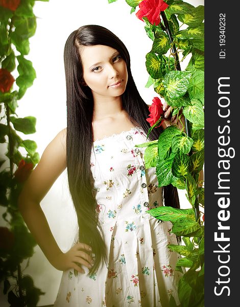 Cute Girl Near The Arch Entwined By Roses