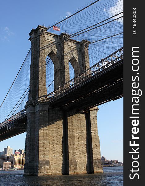 Brooklyn Bridge West Tower With American Flag and Blue Sky