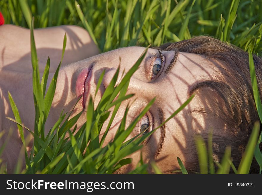 Portrait of young smiling woman on the grass