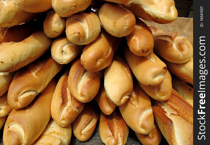 Many baguettes in a bakery for breakfast. Many baguettes in a bakery for breakfast