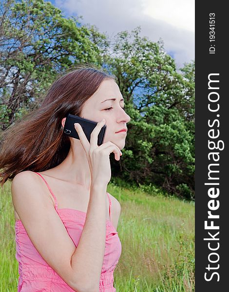 Young woman talking on a mobile phone. Young woman talking on a mobile phone