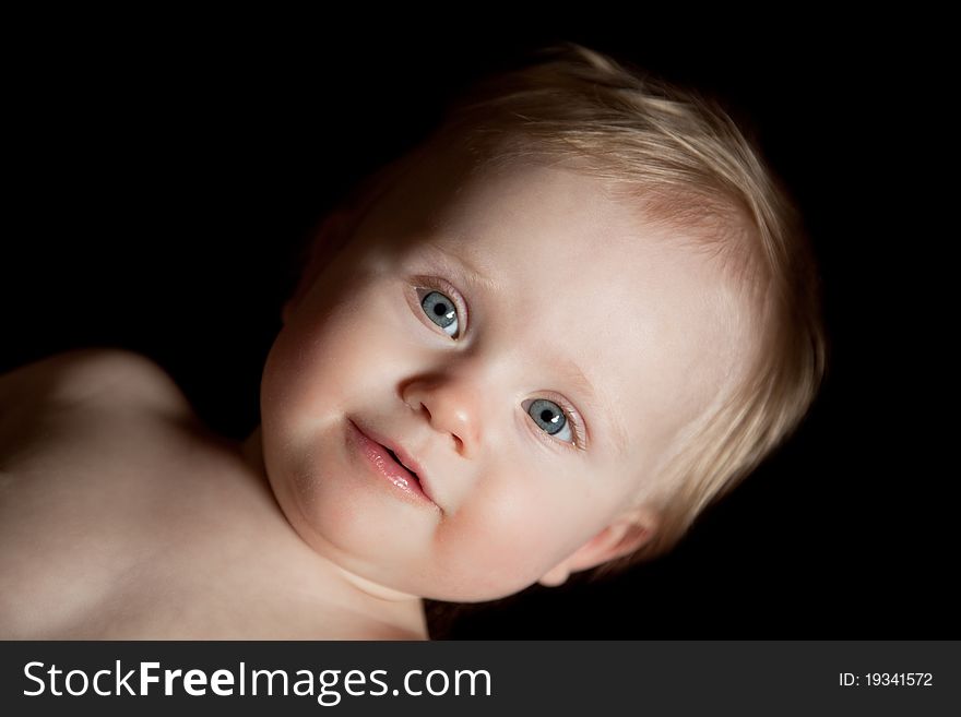 Cute baby girl on black background