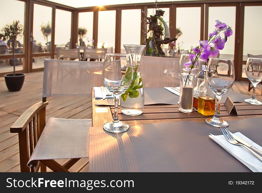 Beach terrace with table by sundown. Beach terrace with table by sundown