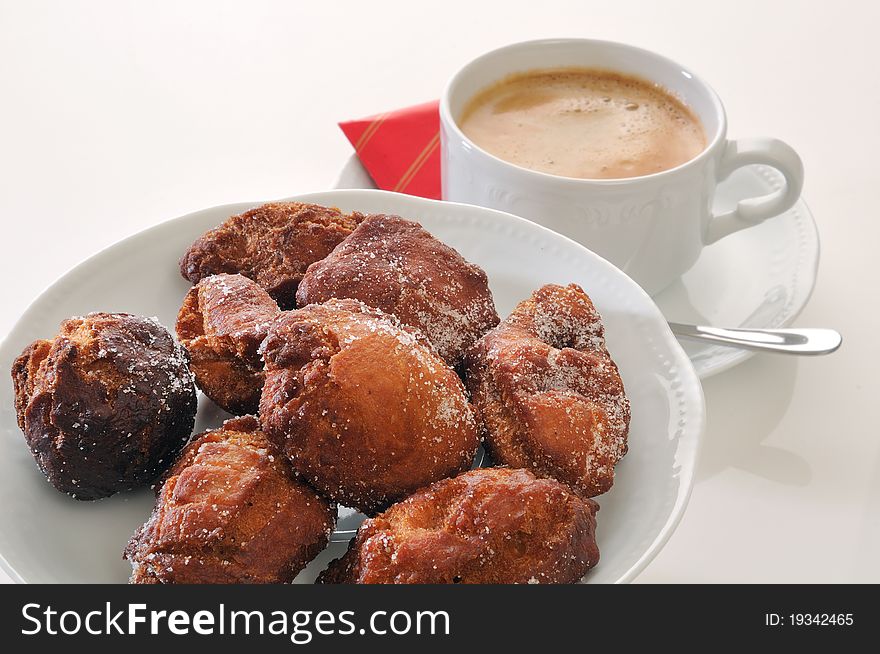 Traditional spanish fritters and a white coffee