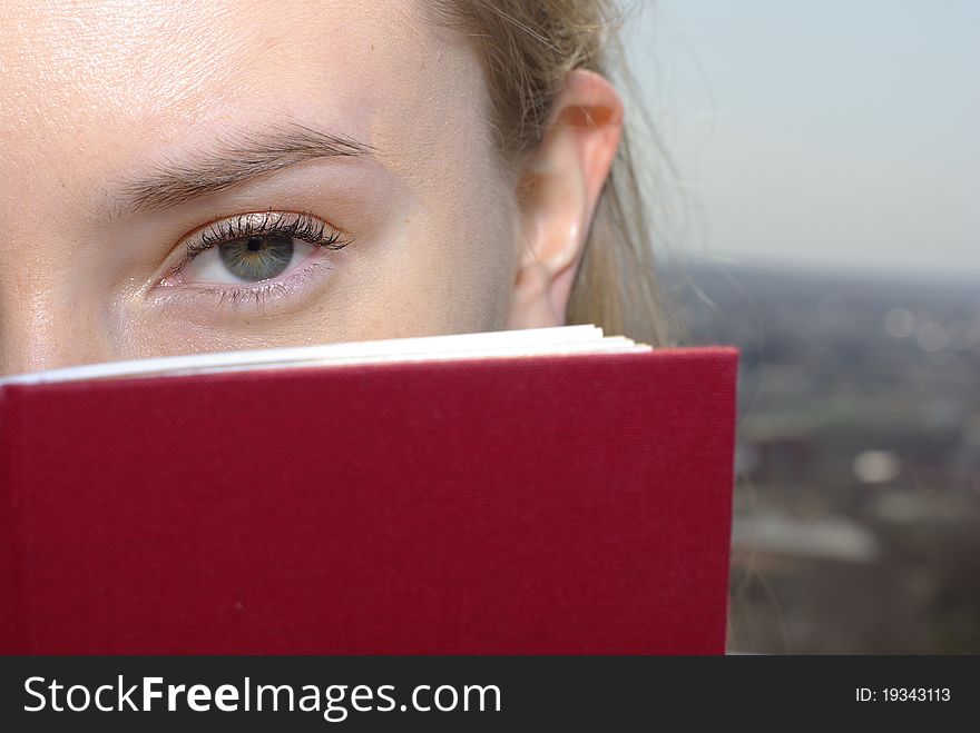 Young caucasian girl with a red book