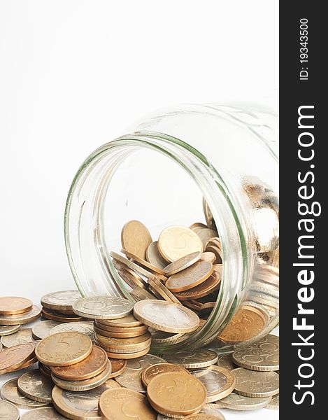 Coins in jar on white background. Coins in jar on white background