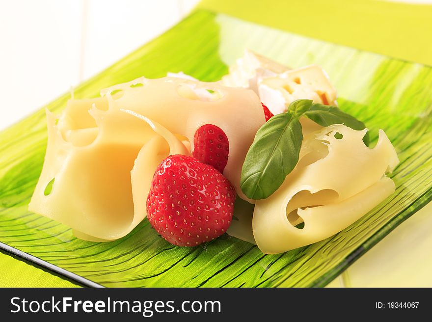 Cheese and fresh strawberries on a plate. Cheese and fresh strawberries on a plate