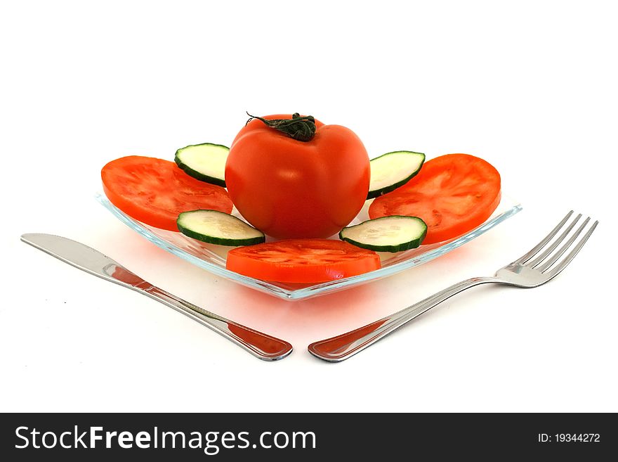 Salad made of fresh tomato, cucumber and paprika served on glass plate