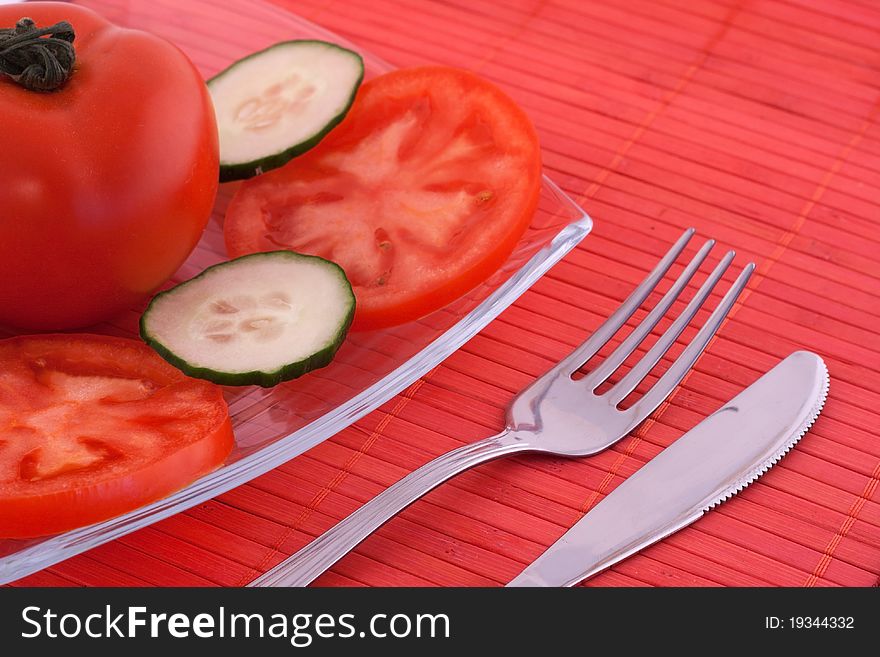 Salad made of fresh tomato and cucumber served on glass plate