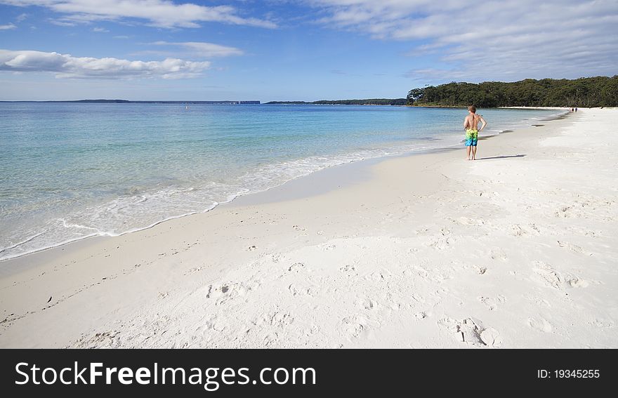 Man fishing on a Tropical beach with white sand and clear water. Man fishing on a Tropical beach with white sand and clear water