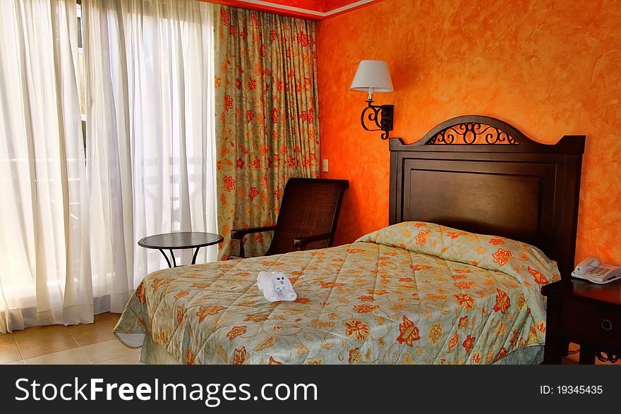 Hotel room with towel decoration on the bed. Mexico tropical resort.