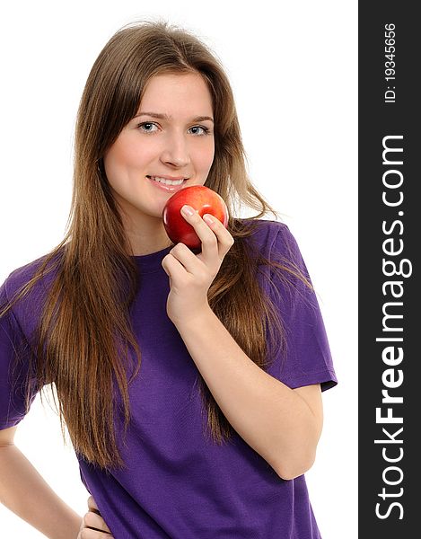 Portrait of cheerful young woman holding a red apple and smiling isolated against white background