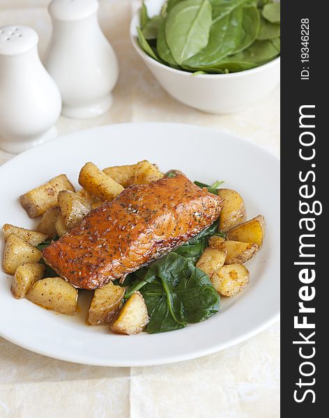 Spice-crusted salmon with roast potatoes and spinach. Spice-crusted salmon with roast potatoes and spinach