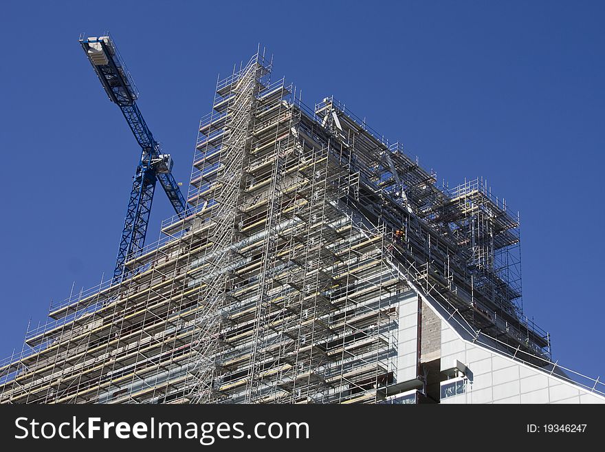 Construction of new building with one crane in background