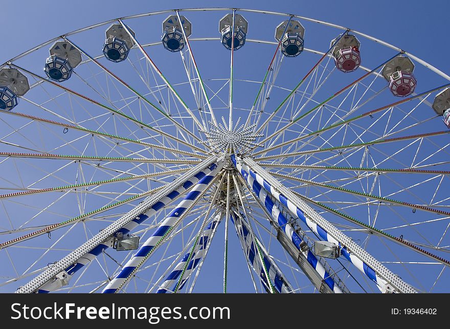 Under big ferris wheel on blue sky background. Under big ferris wheel on blue sky background