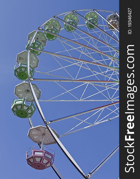 Close-up of big ferris wheel on blue sky background. Close-up of big ferris wheel on blue sky background