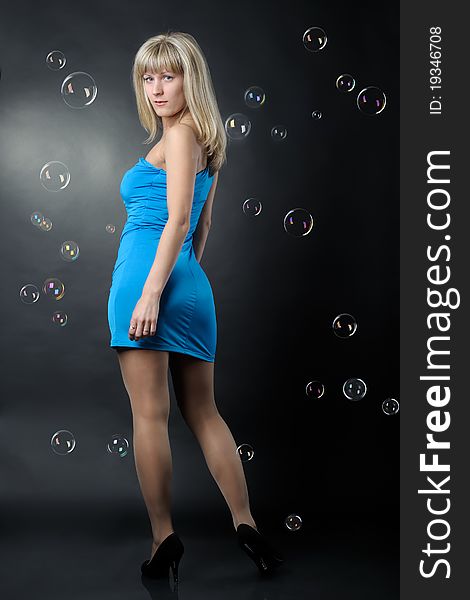 Woman in blue dress on balck background