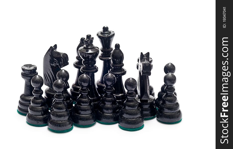 Black chess figurines over a white background