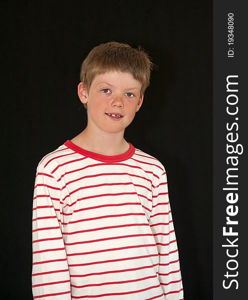 Adorable young boy isolated on a black background