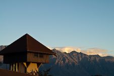 Wooden House On Rooftop With Mountain In The Backg Royalty Free Stock Photography