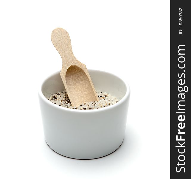 Salt cointaner with spoon isolated on white background.