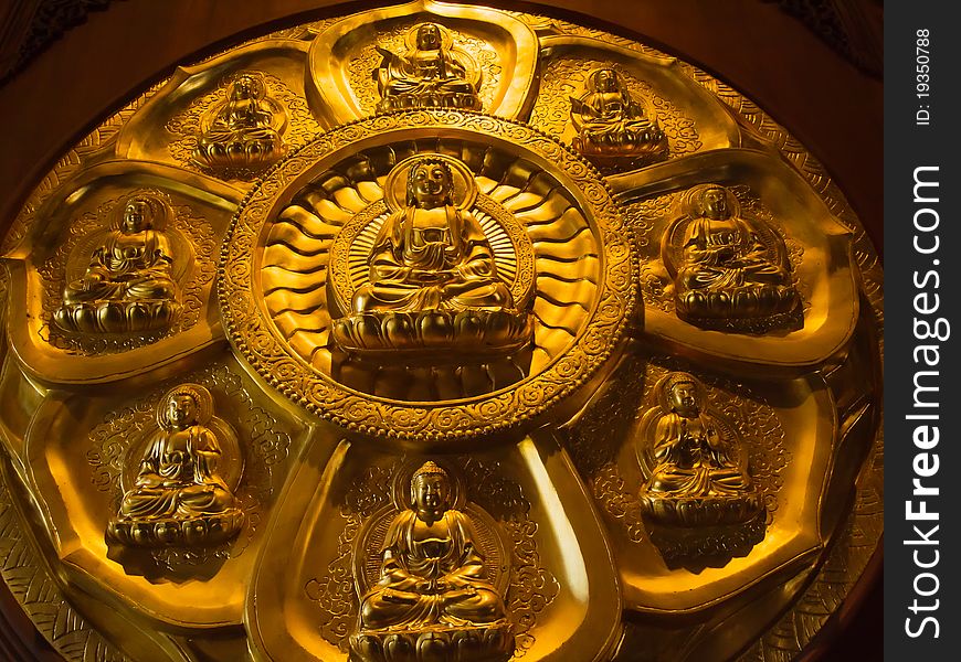 Buddha on lotus carved wood with gold paint over