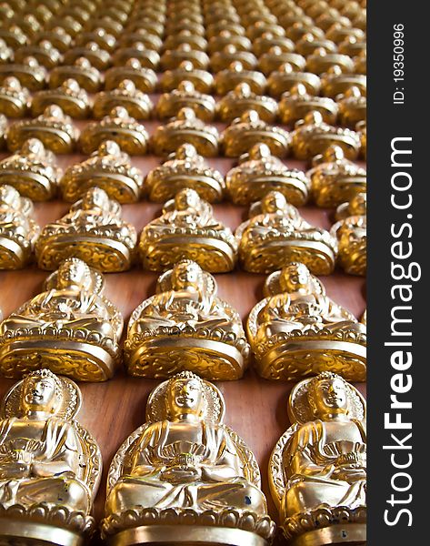 Many small Buddha statue on the wall at chinese temple in Thailand (Vertical). Many small Buddha statue on the wall at chinese temple in Thailand (Vertical)
