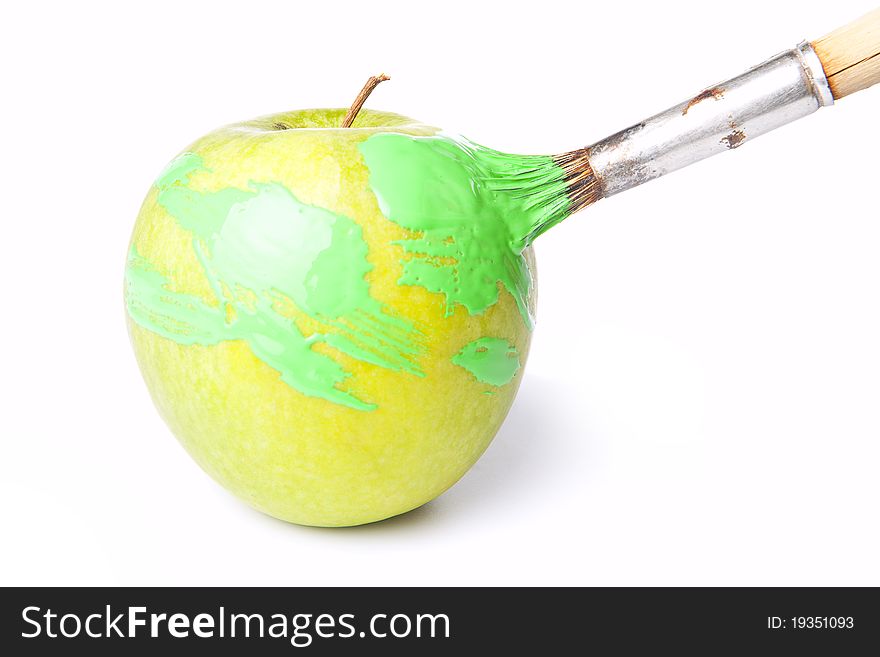 Bright green apple with brush and a paint on white. Bright green apple with brush and a paint on white