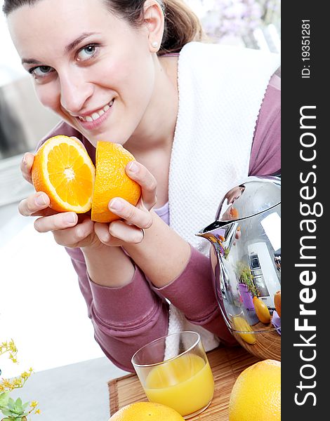 Girl in the kitchen, preparation squeezed oranges. Girl in the kitchen, preparation squeezed oranges