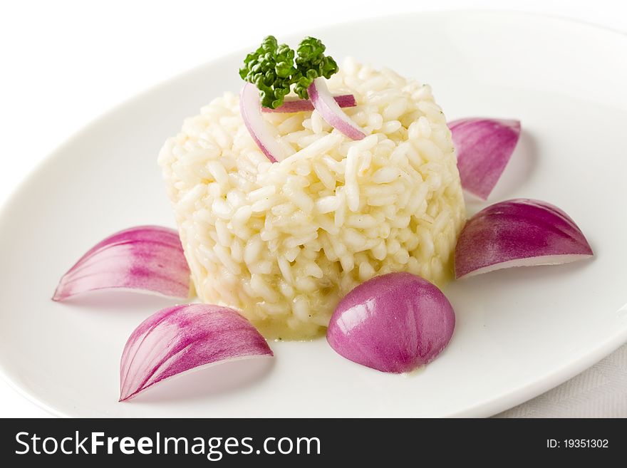 Photo of delicious risotto with red onions on white isolated background