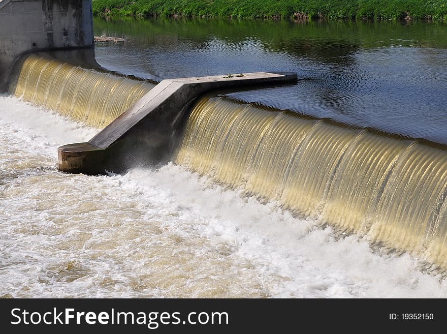 In most cases weirs take the form of a barrier across the river that causes water to pool behind the structure (not unlike a dam), but allows water to flow over the top.