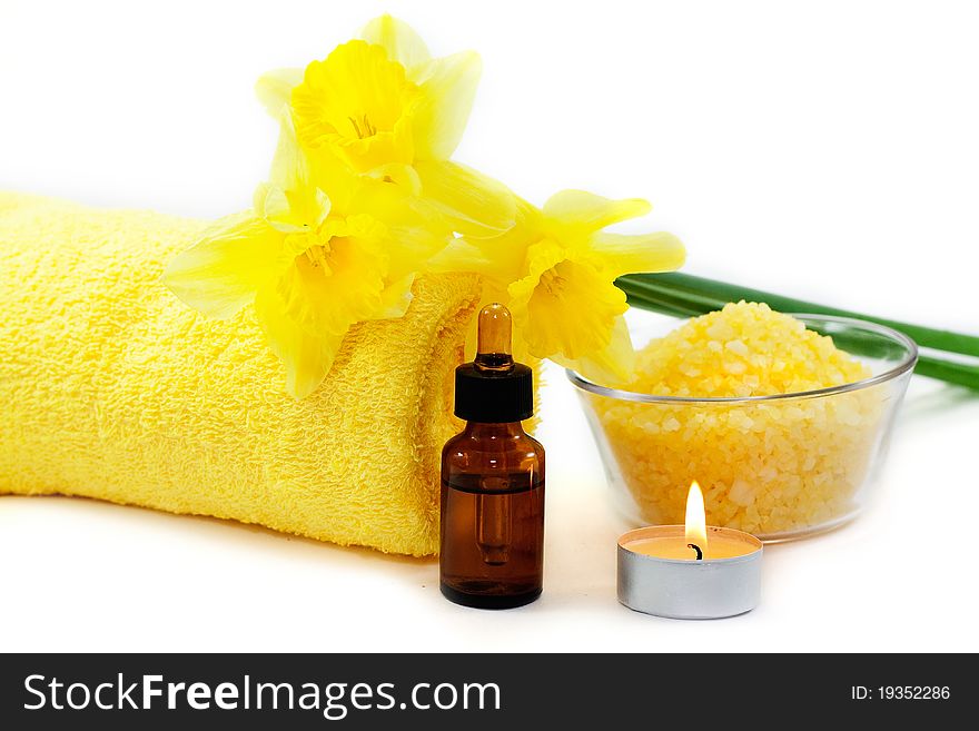 Sea salt, a towel, holding candles and daffodils isolated on white background. Sea salt, a towel, holding candles and daffodils isolated on white background