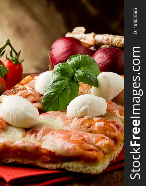 Delicious slice of pizza with buffalo mozzarella on wooden table