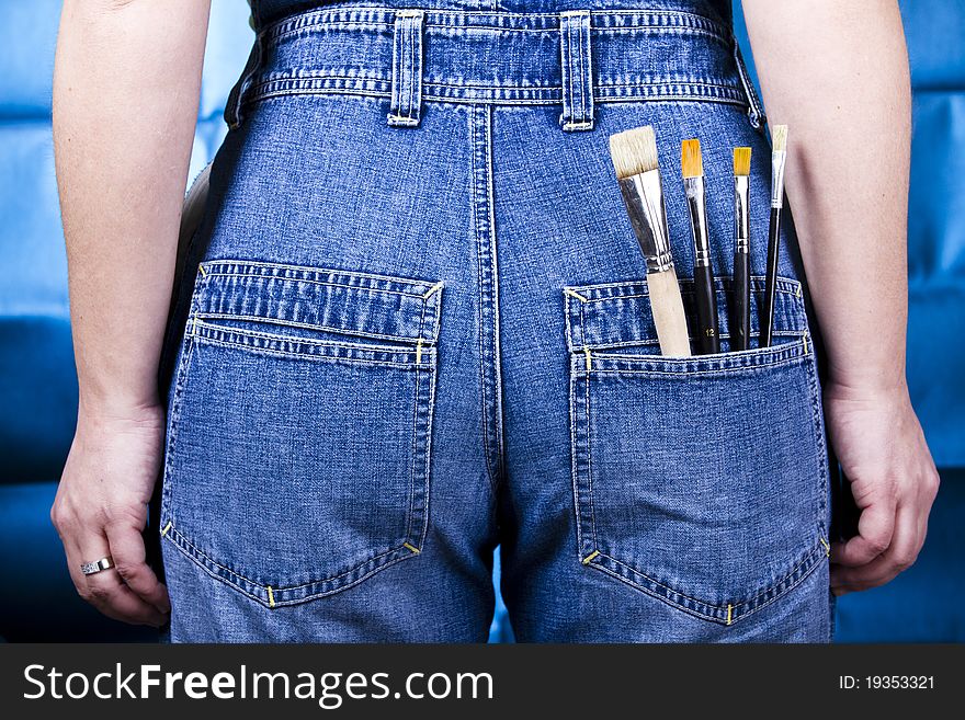 Woman wearing jeans with brushes in pocket. Woman wearing jeans with brushes in pocket