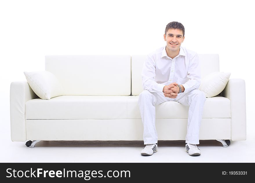 Portrait of the young man in white on sofa