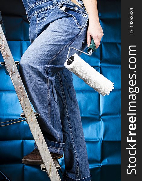 Woman painting holding a brush climbing a ladder