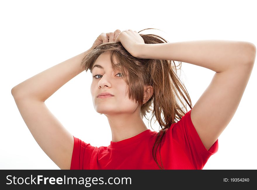 Young woman playing with her â€‹â€‹hair on white background