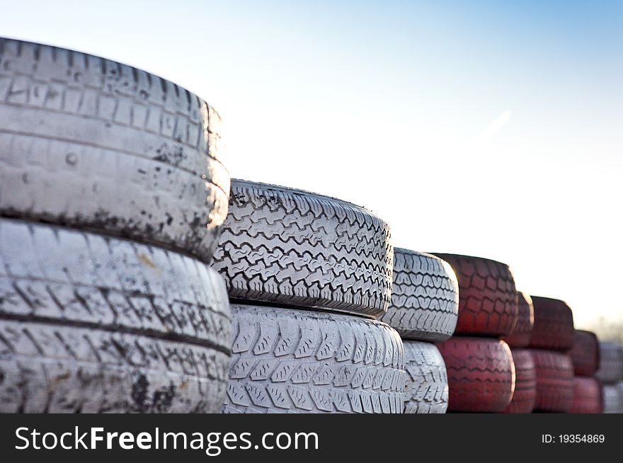 Close up of racetrack fence of red and white old tires