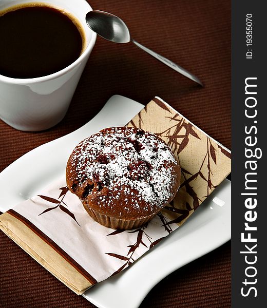 Chocolate cherry muffin with coffee - breakfast concept